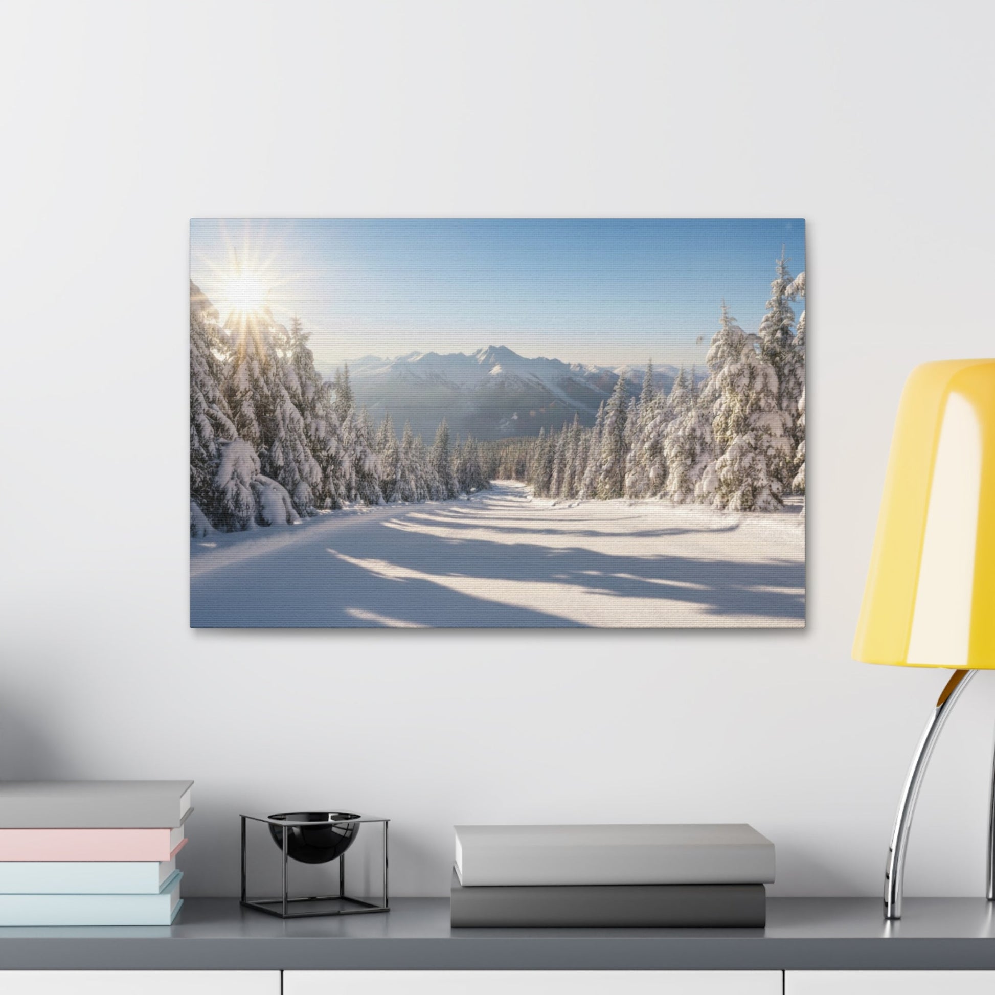 Canvas wall art depicting a serene winter trail with snow-covered pine trees and distant mountains under a bright morning sun