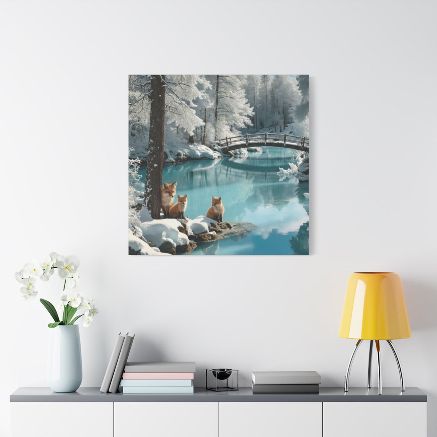 Winter foxes canvas wall art depicting serene snowy landscape with a bridge over calm water