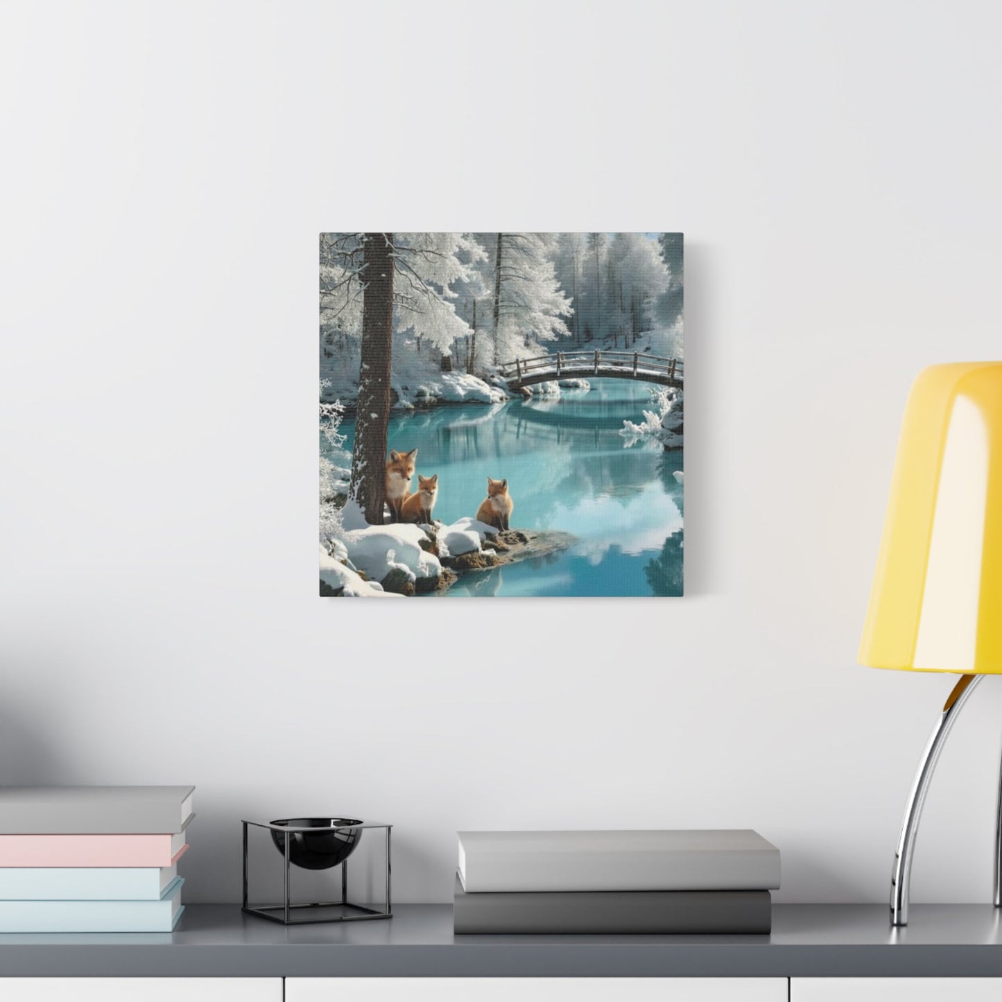 Canvas wall art featuring serene winter landscape with foxes by a snowy river and wooden bridge