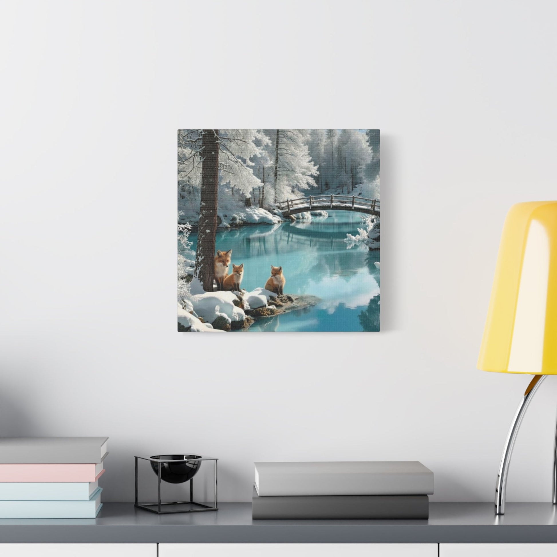 Canvas wall art featuring serene winter landscape with foxes by a snowy river and wooden bridge