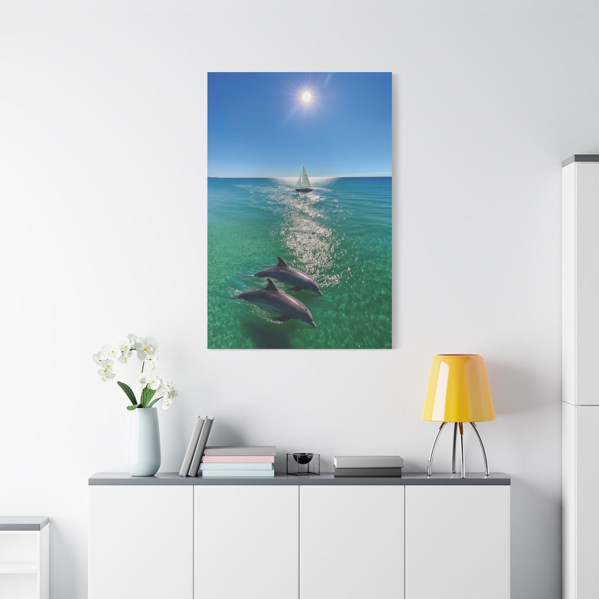 Wall art canvas print featuring sailboat and dolphins in ocean under sunny sky for nautical decor