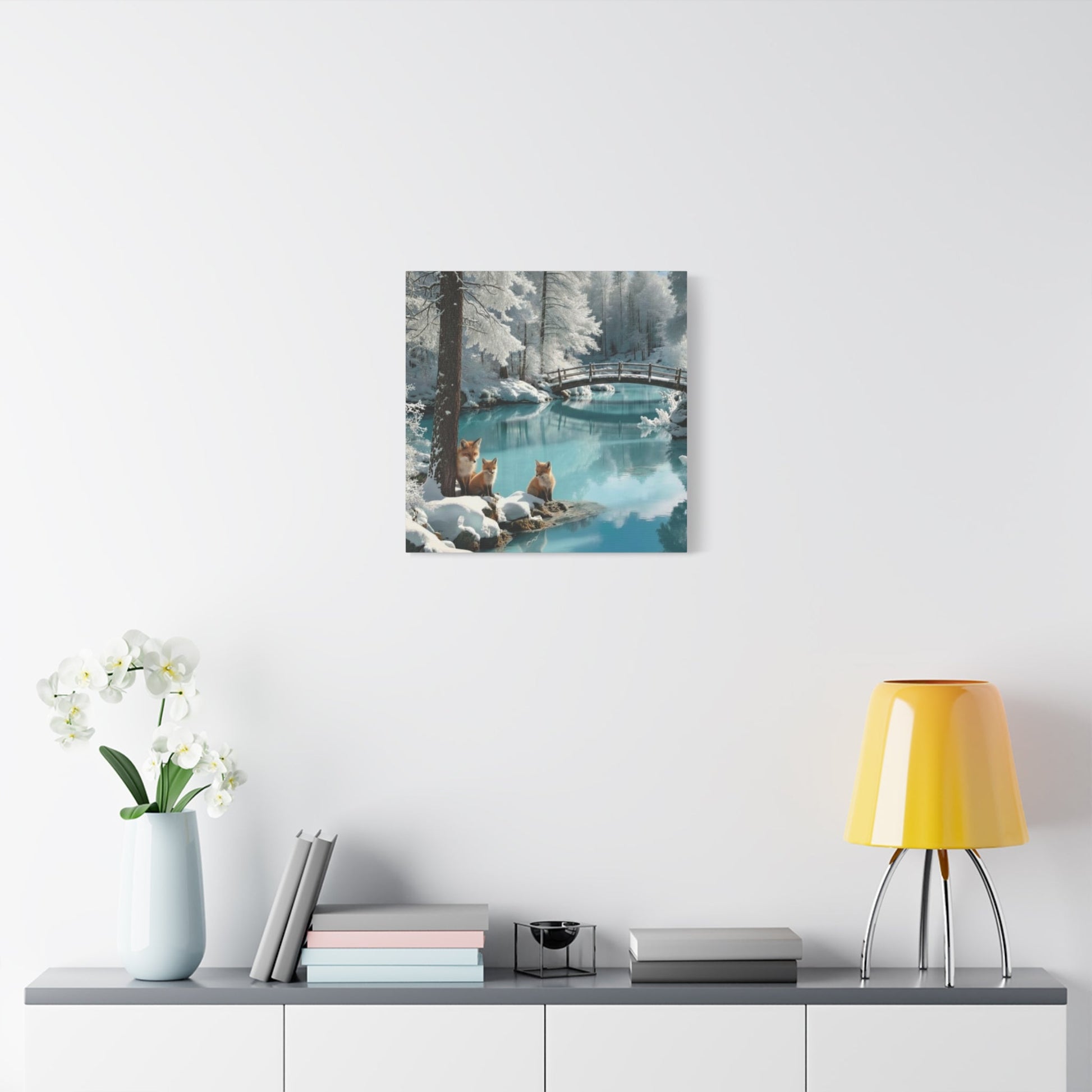 Canvas wall art featuring winter foxes by a serene snowy lake with a bridge, perfect for nature-inspired home decor.