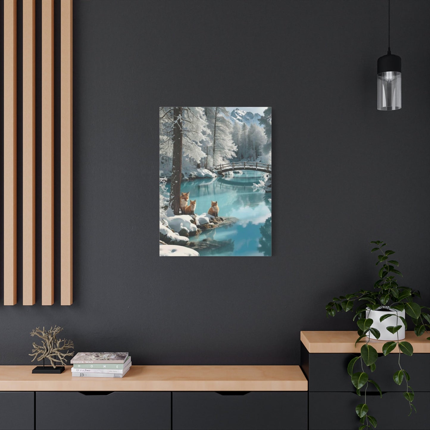 Canvas wall art featuring winter foxes by a serene snowy river with a bridge, displayed in a modern living room.