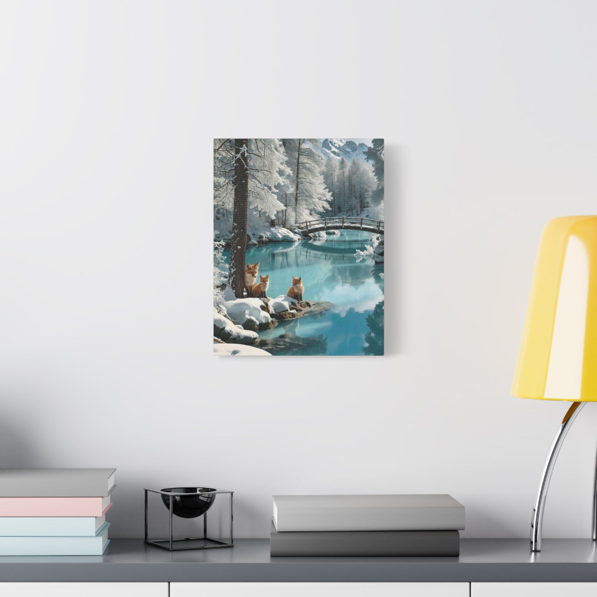 Canvas wall art featuring winter foxes by a serene snowy lake with a rustic bridge, perfect for cozy home decor