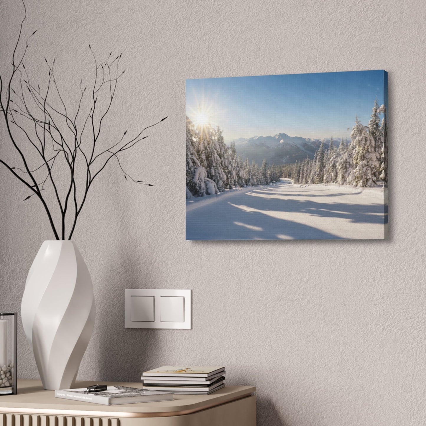 Canvas wall art depicting a serene winter trail with snow-covered pine trees and mountains under a clear blue sky, mounted on a pinewood frame.