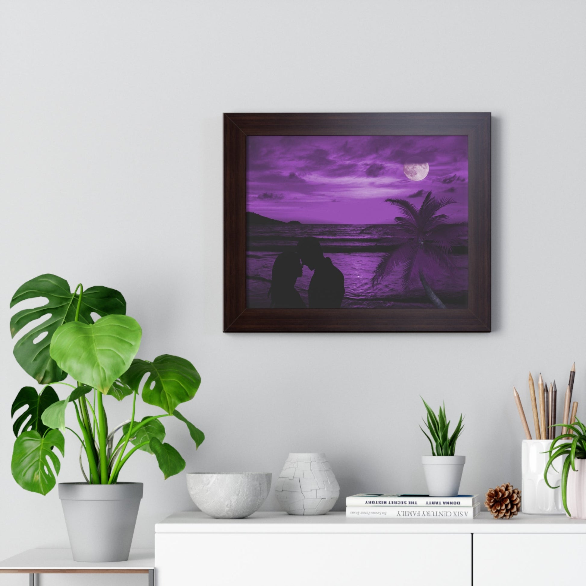 Romantic purple framed poster of a beach couple silhouette at sunset with palm trees and ocean backdrop in bedroom decor setting