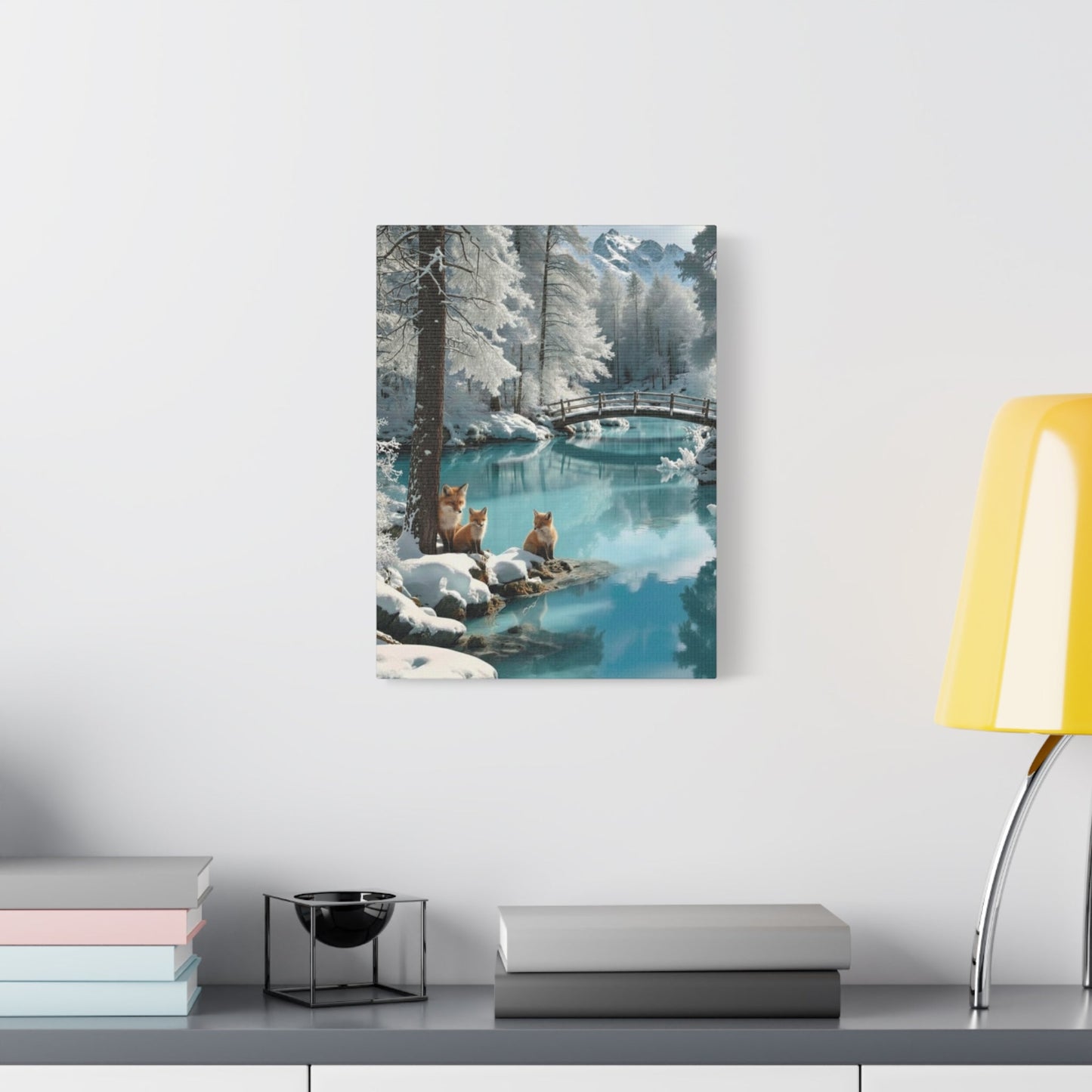Canvas wall art featuring winter foxes by a snowy river landscape hanging in modern room