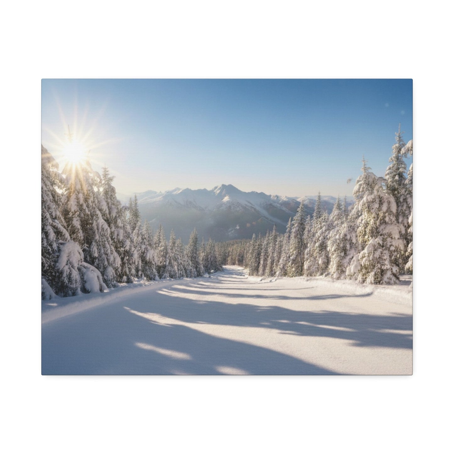 Canvas wall art depicting a serene winter trail with snow-covered trees and mountains under a bright morning sun