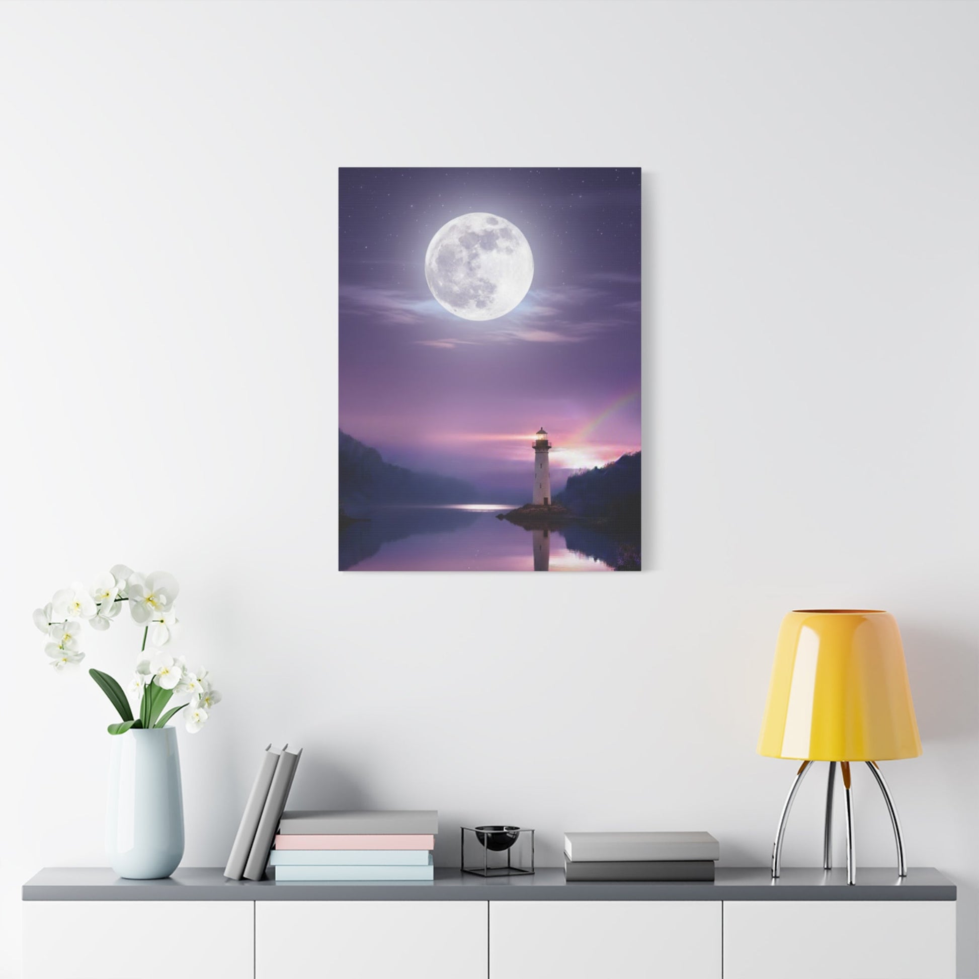 Canvas wall art depicting a tranquil lighthouse and full moon reflecting over a calm lake in violet and indigo tones