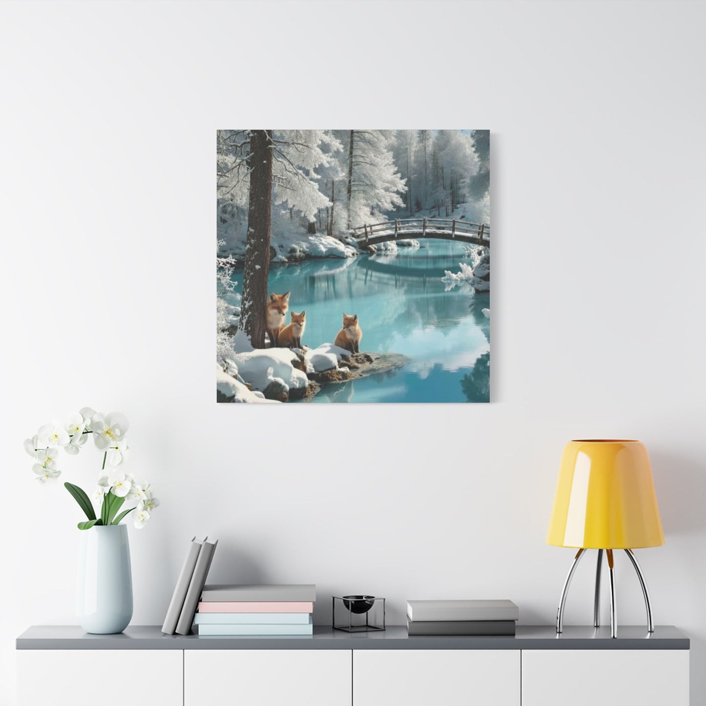 Canvas wall art featuring winter foxes by a serene snowy river with a wooden bridge, enhancing cozy home décor.