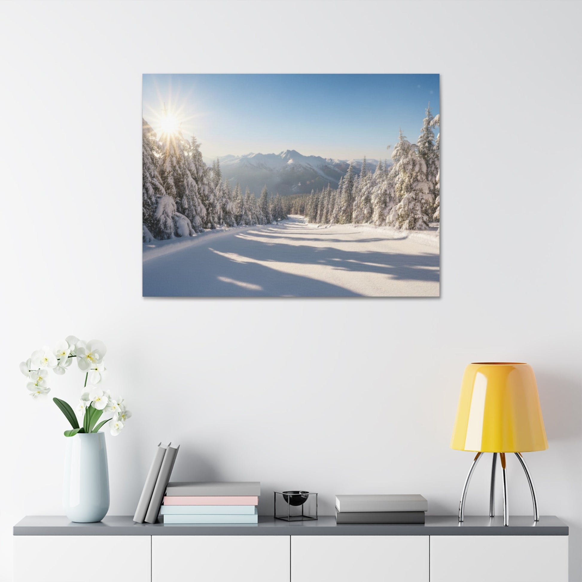 Canvas wall art of a peaceful snowy winter trail with sunlit snowy pines and distant mountains