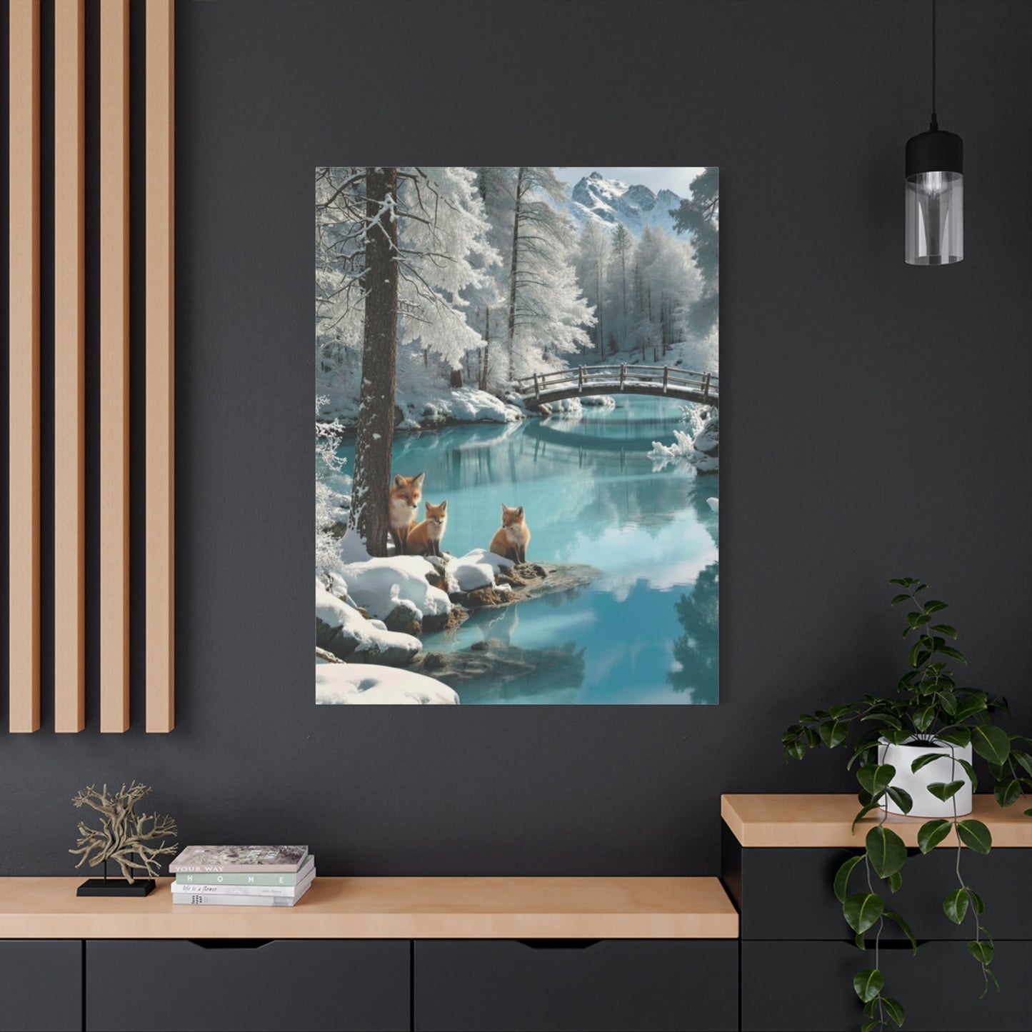 Canvas wall art featuring winter foxes by a serene snowy lake with a wooden bridge in a modern living room setting