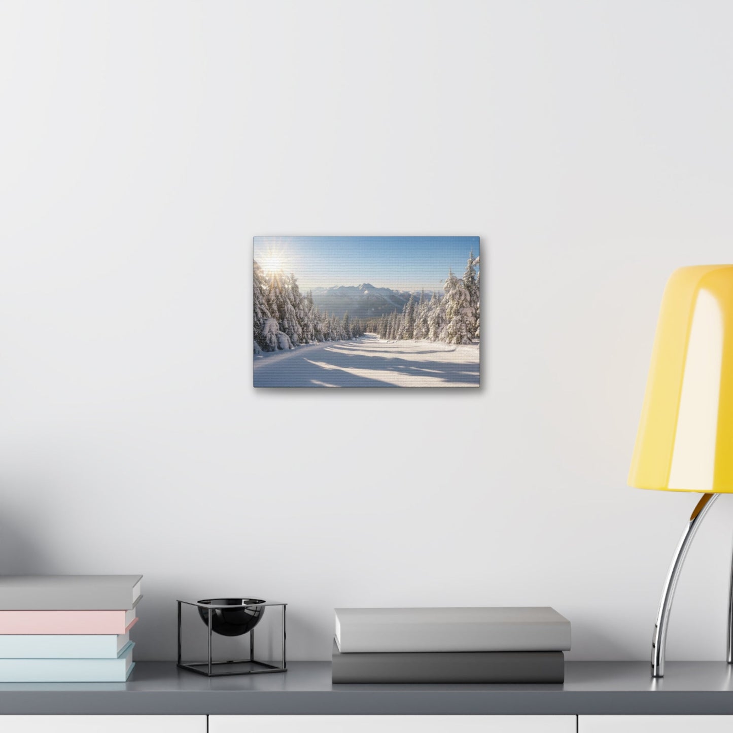 Canvas wall art depicting a tranquil snowy winter trail with pine trees and distant mountains under a clear sky