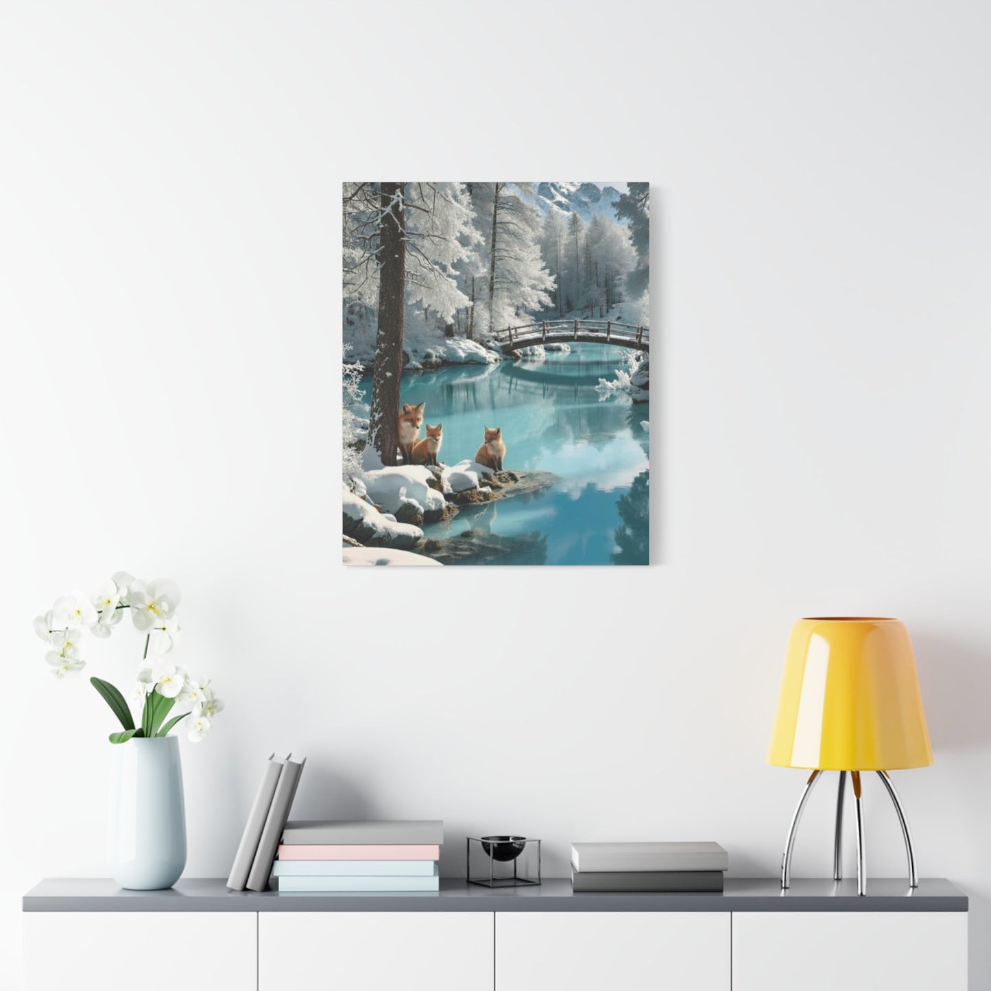 Canvas wall art depicting winter foxes by a snowy river with a wooden bridge in the background, perfect for cozy home décor.