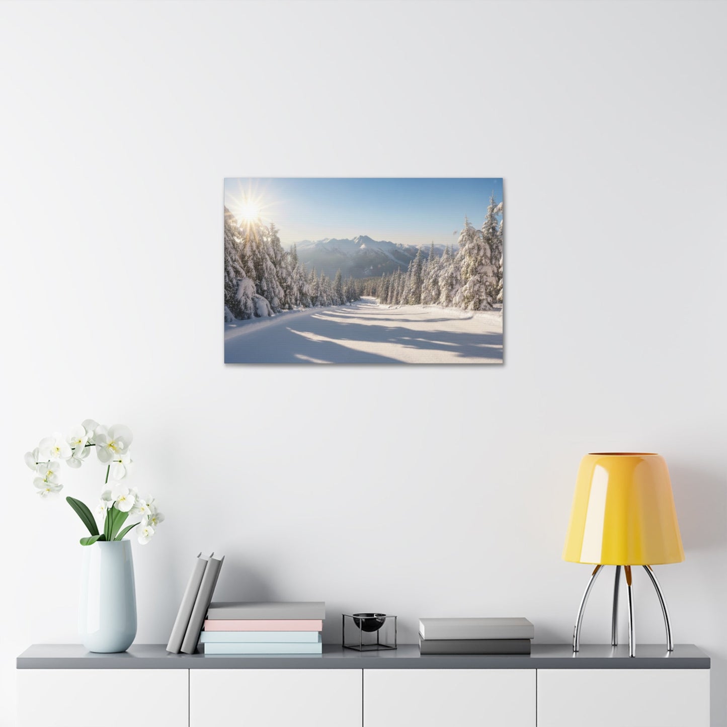 Canvas wall art featuring a serene wintry trail with snow-covered pines and mountains under a clear sky
